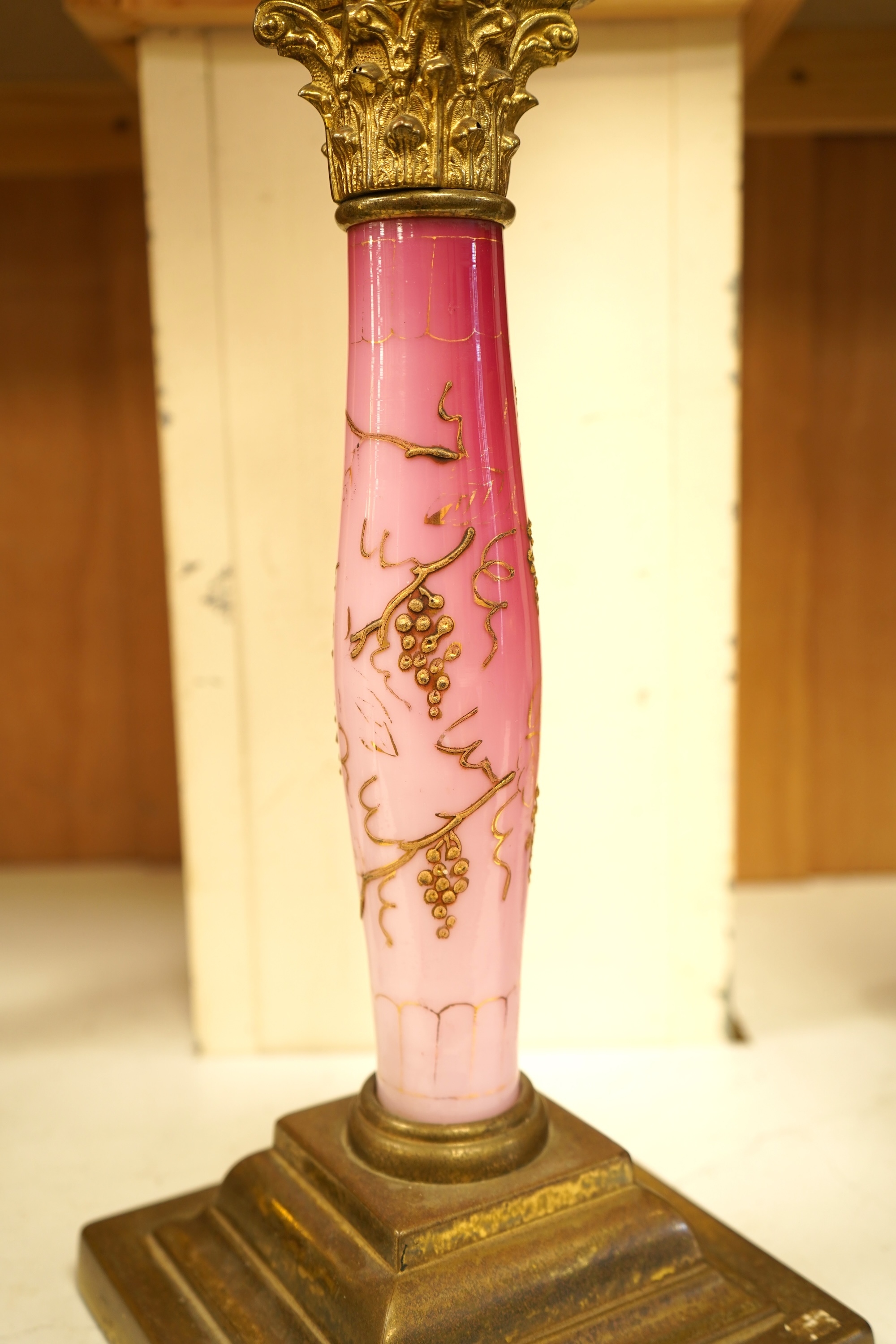A Victorian brass and ruby glass oil lamp, 80cm high overall